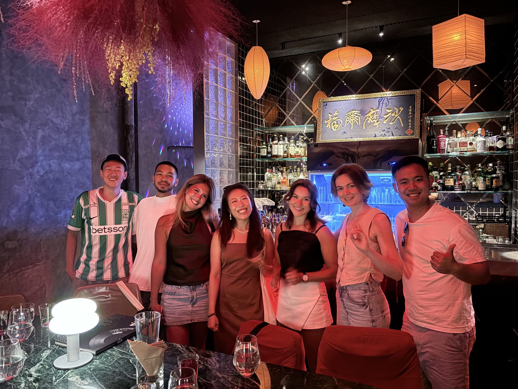 Bar crawl group cheersing at a Chengdu bar