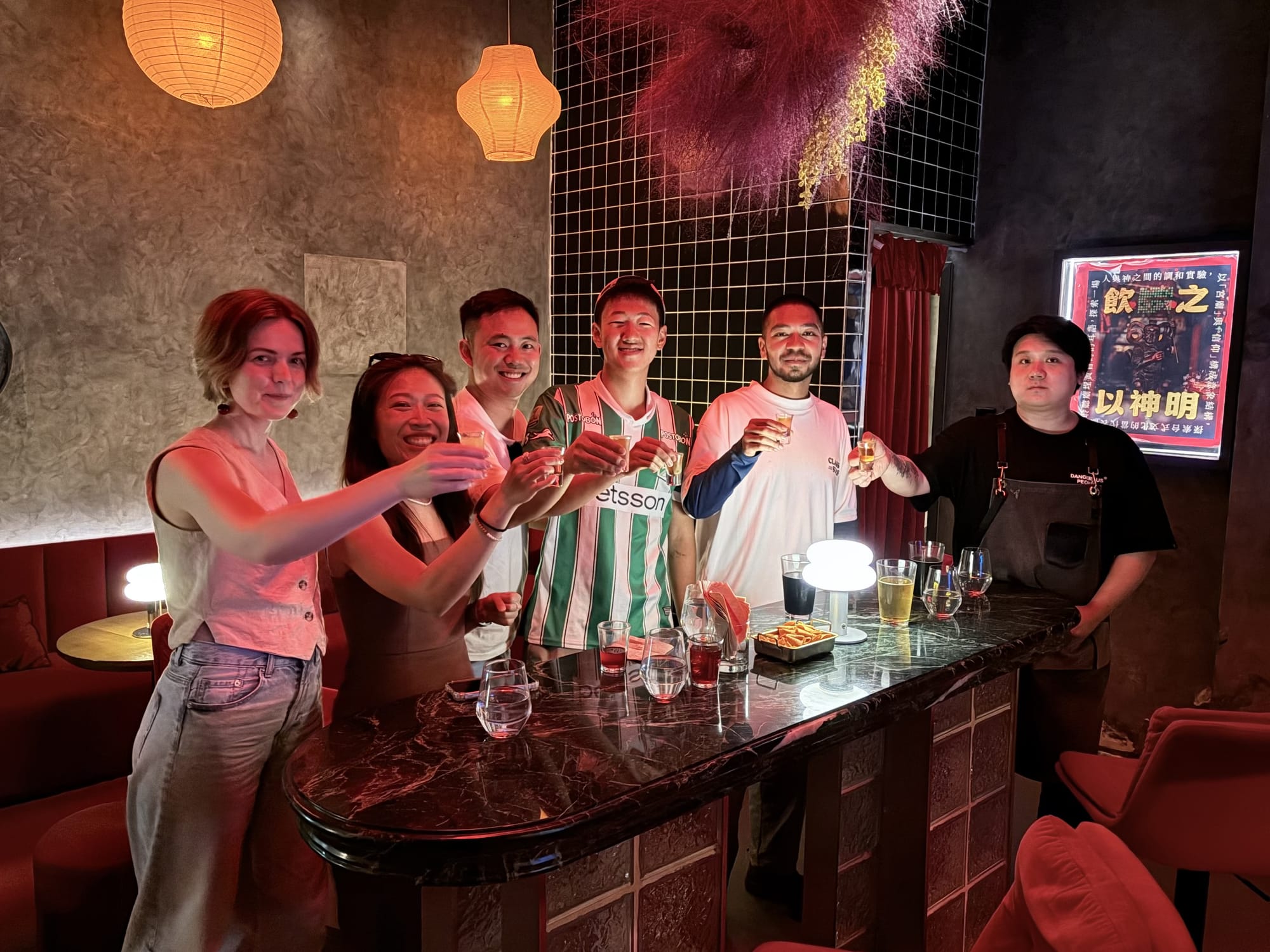 Bar crawl group with drinks at a Chengdu bar
